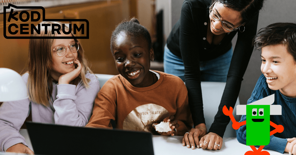 Fyra glada barn framför en laptop. En liten grön robot i förgrunden. 